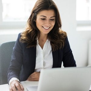 woman in blazer with laptop