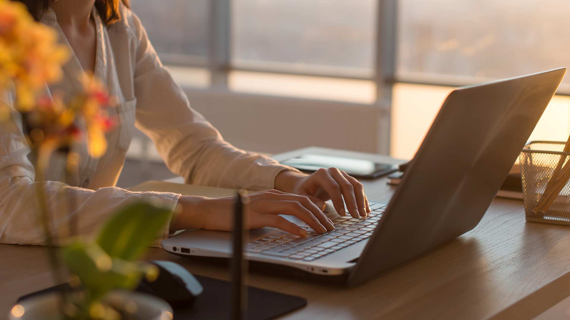 feminine hands on laptop keyboard