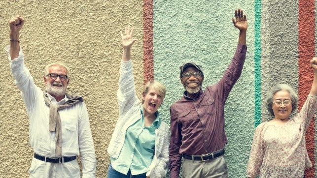 group of seniors raising their hands