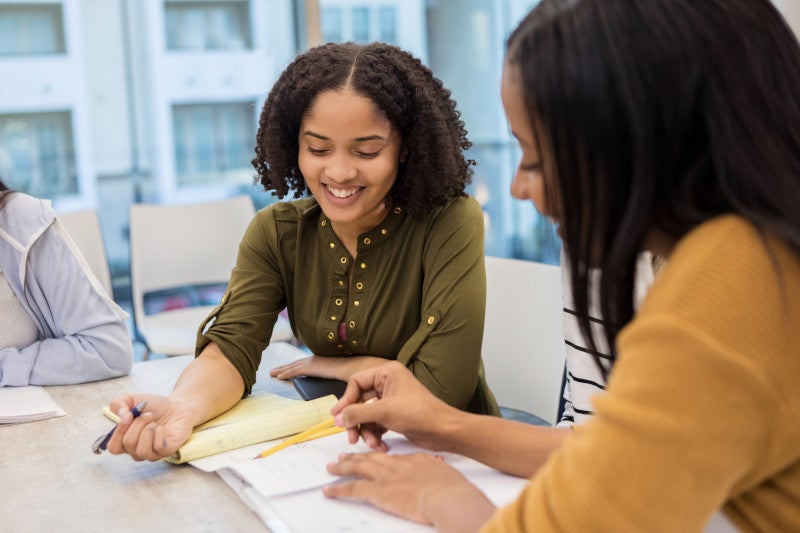 woman counseling or teaching another young woman