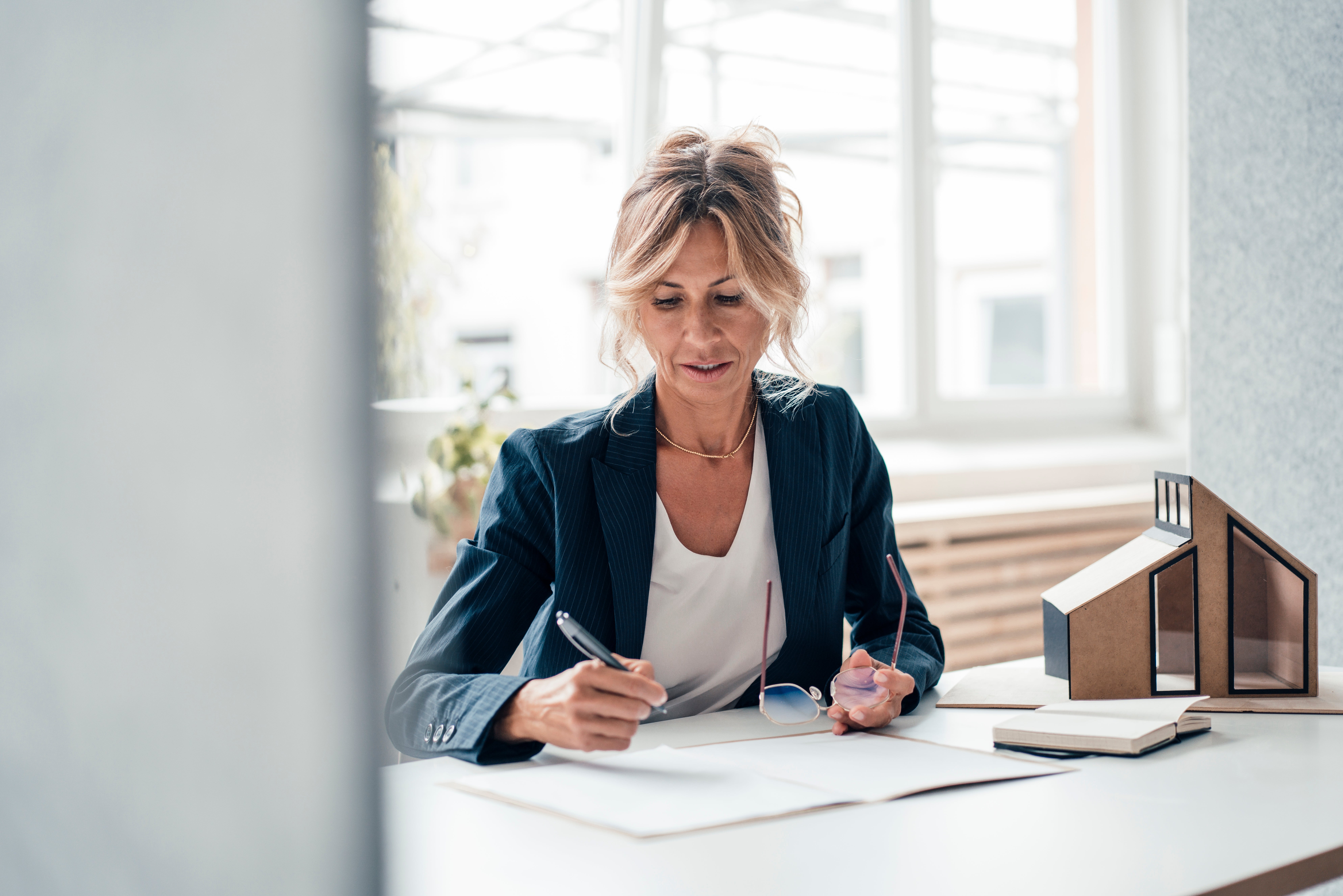Woman looking at real estate contract.