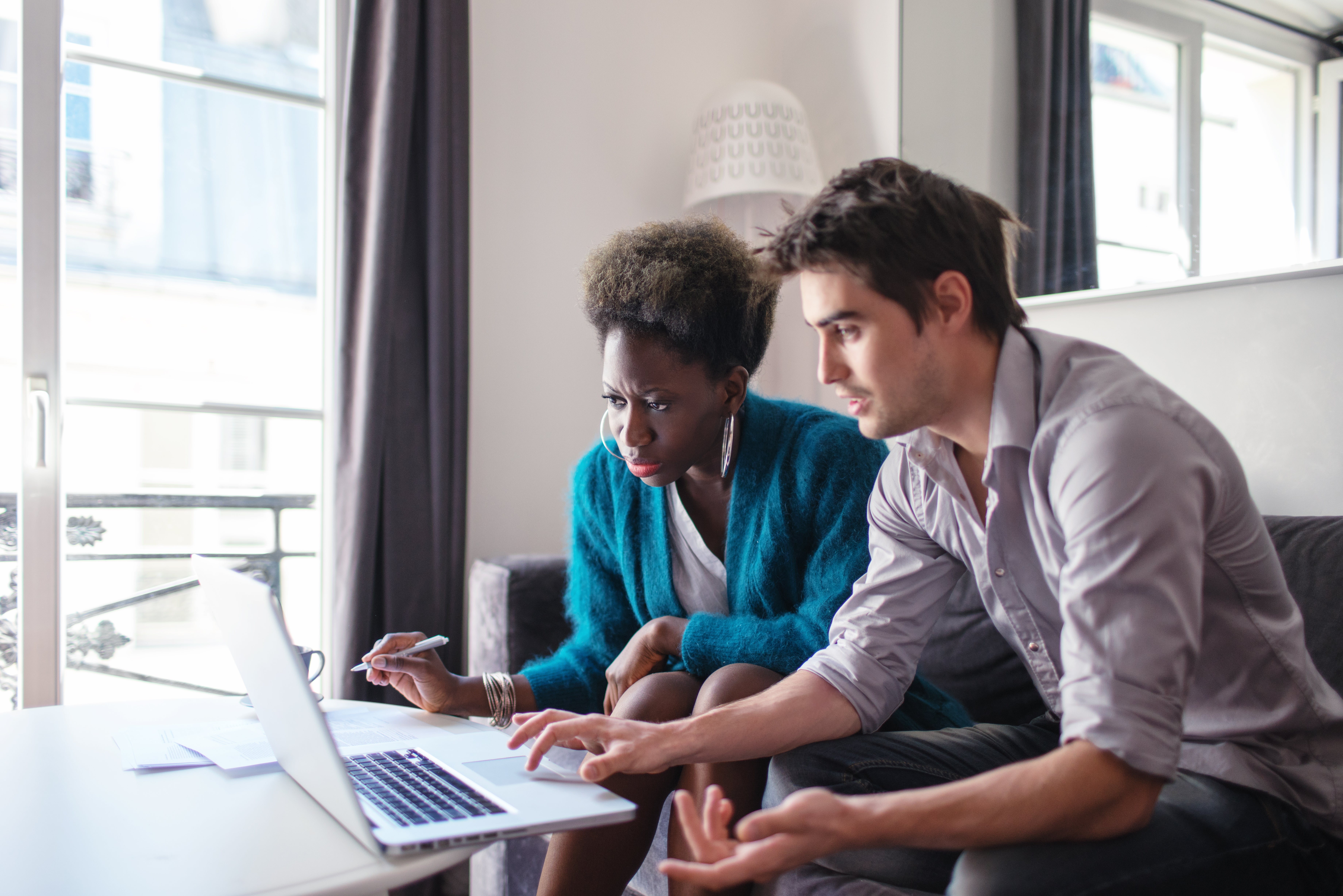 Two people looking at laptop