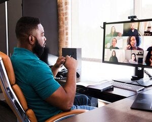 Mid adult manager video conferences with his team