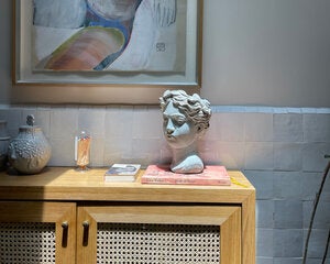 Head sculpture on table