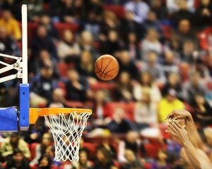 Action shot of a basketball game representing sports management and industry education programs.