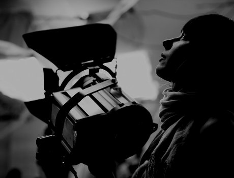 Filmmaker Adjusting Light