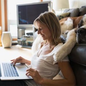 Student at laptop with dog