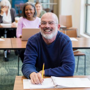 mature man smiling in classroom