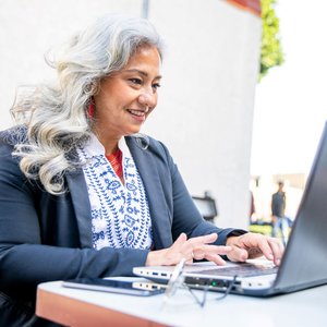 senior woman outside on laptop