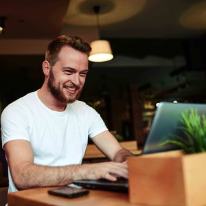 man in white shirt on a laptop