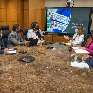 meeting of public health officials on infection control in a conference room