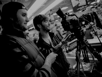 Two cinematographers using a camera