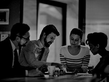 Shot of a group of colleagues working together in an office