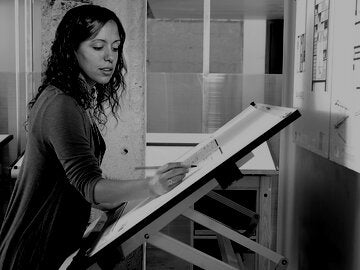 Female architect student working on design plan.