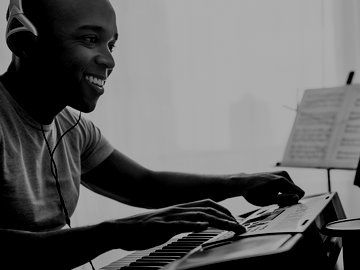 Musician writing music on computer
