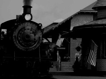 Vintage Antique Steam Locomotive At Railroad Station