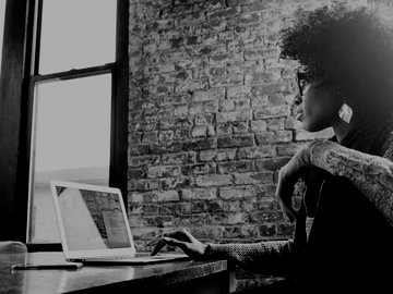 Black businesswoman using laptop at desk