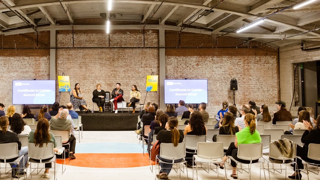 Four panelists speak before a crowd at the Bruin Collaborative