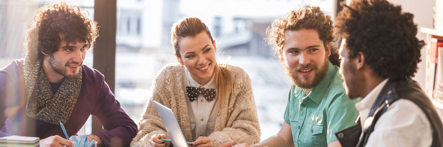 four producers at a pitch meeting