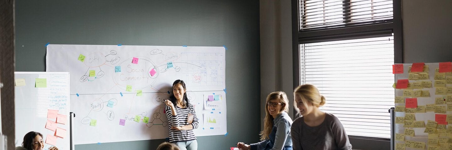 Young professionals problem solving with a whiteboard