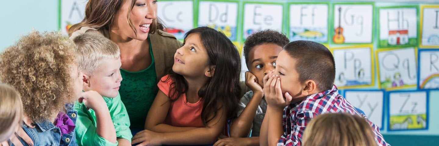 Female preschool teacher and students