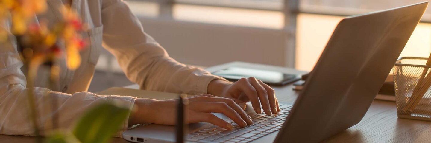 woman's hands on laptop keyboard