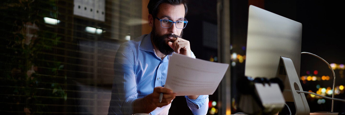 man reading paper work