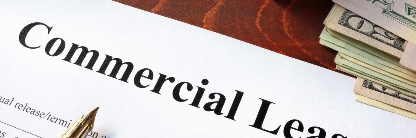 Commercial Lease agreement with money on a table.