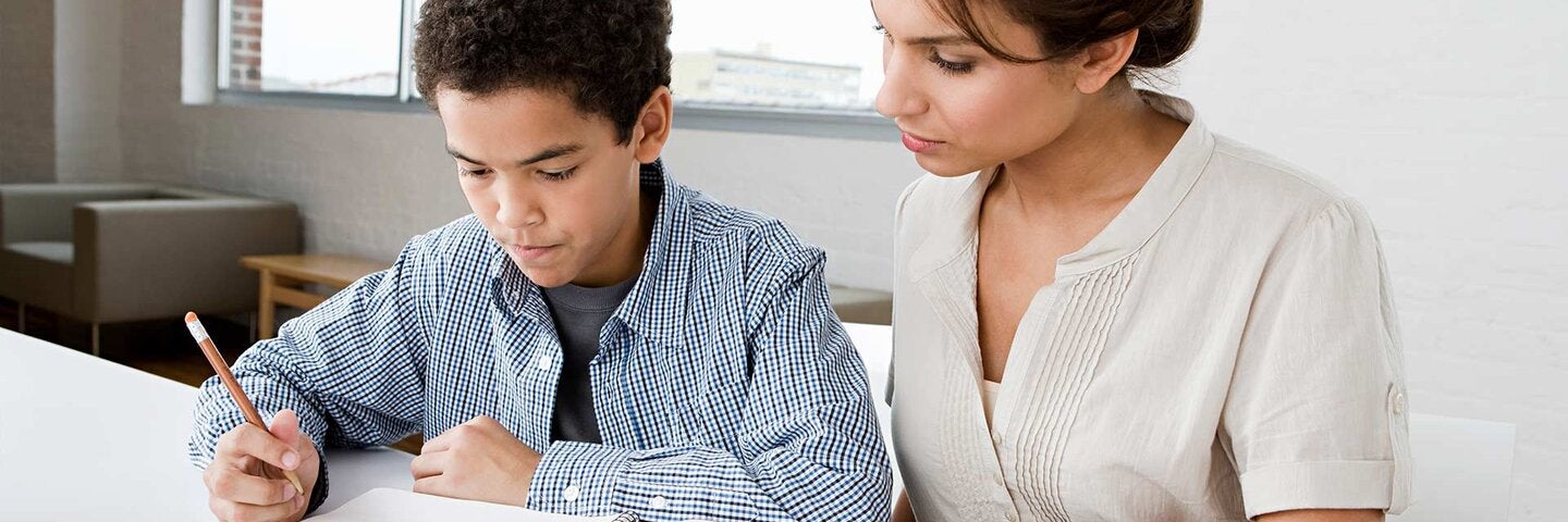 Woman mentoring boy student