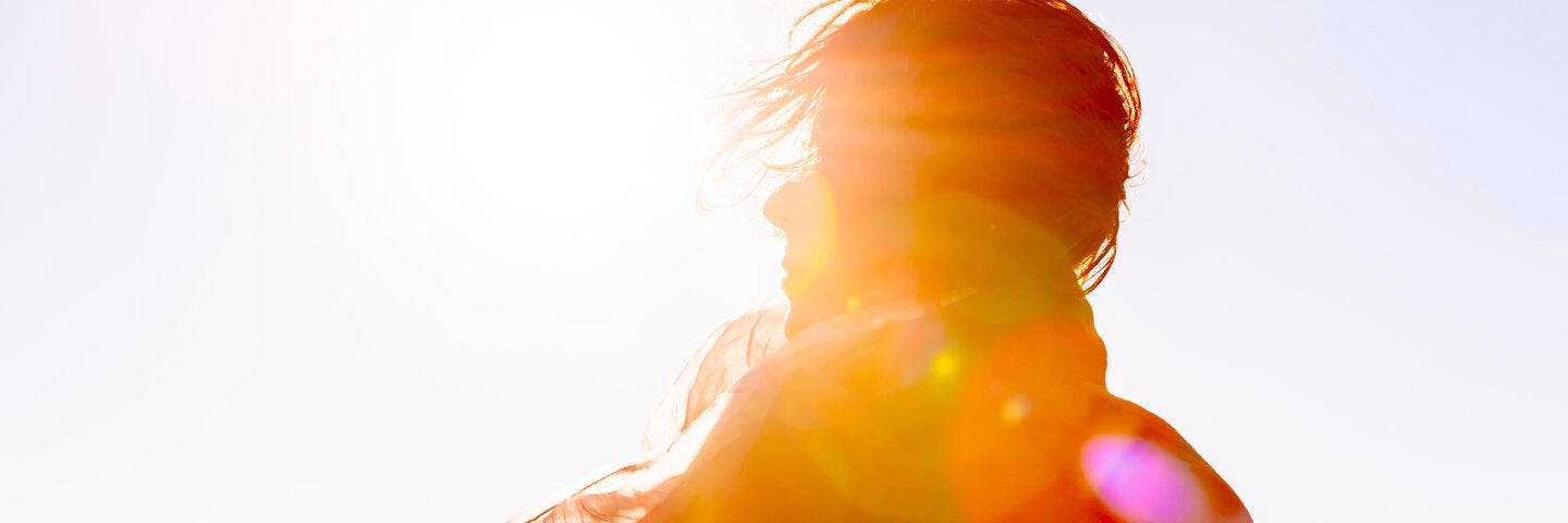 woman's silhouette with sun flare