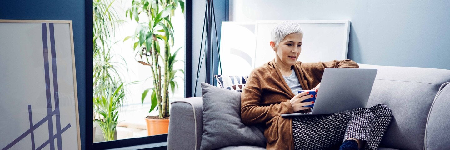senior woman on a laptop in her living room
