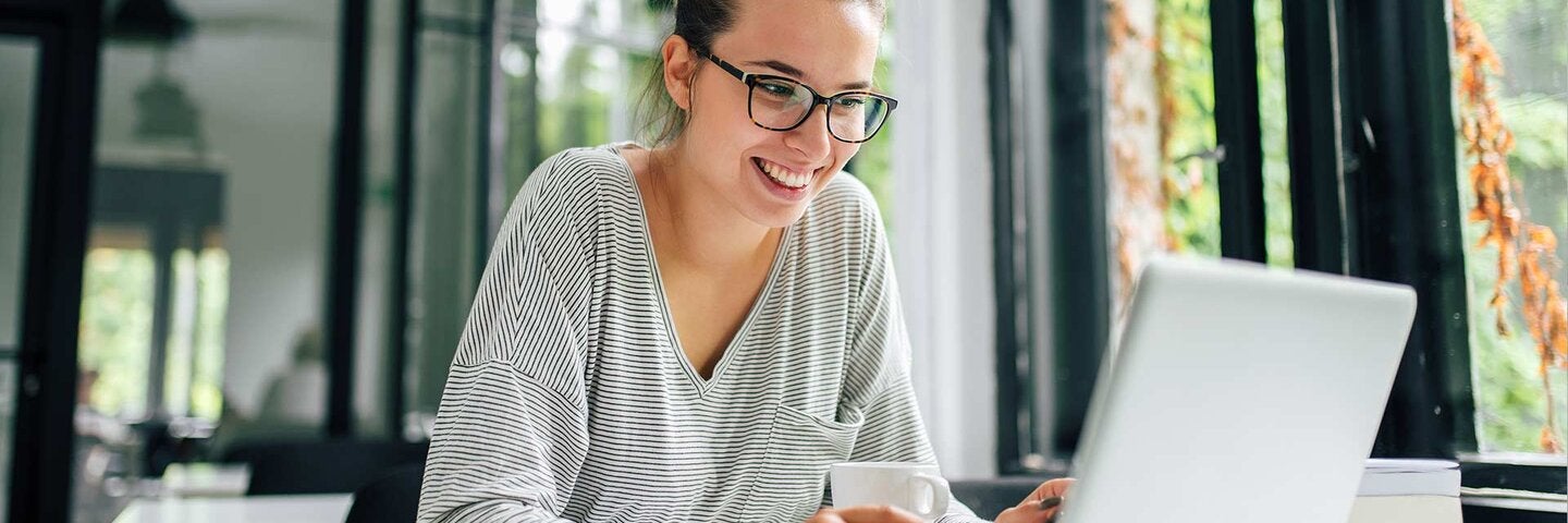 woman in casual clothing using laptop