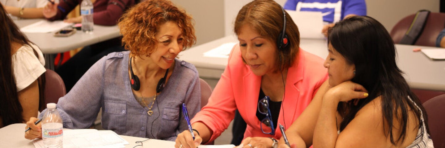 Female instructor teaching two students in the classroom