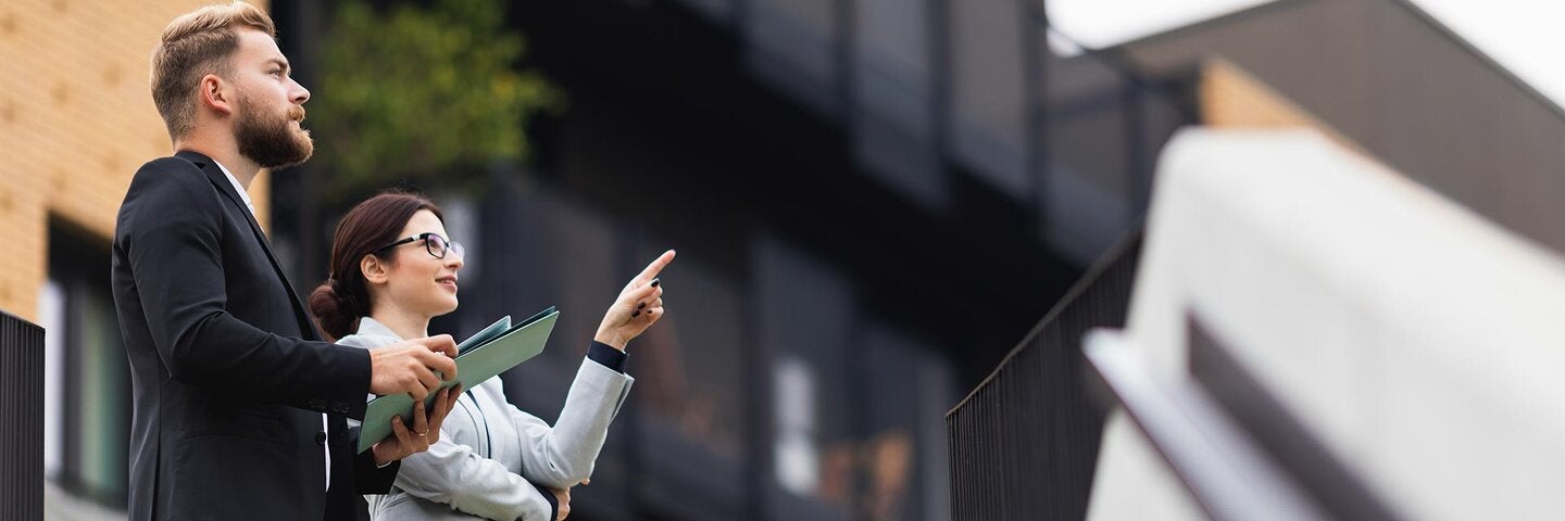 two professional standing outside