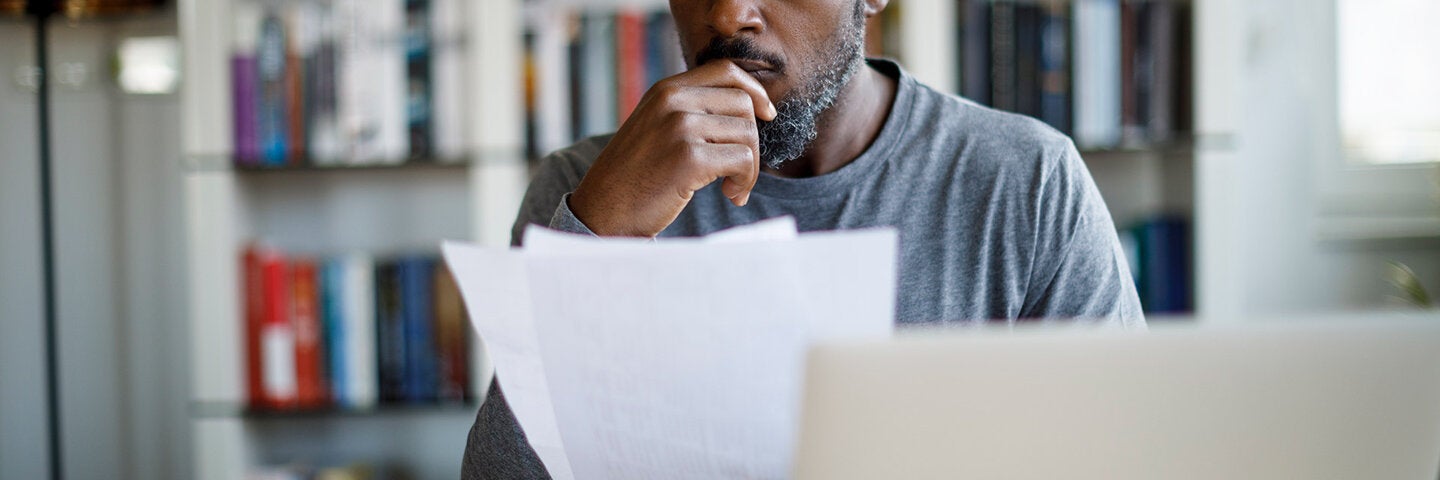 Man reviewing printed documents
