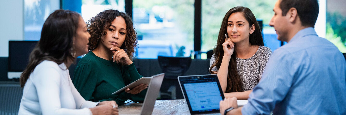 people with laptops having a meeting