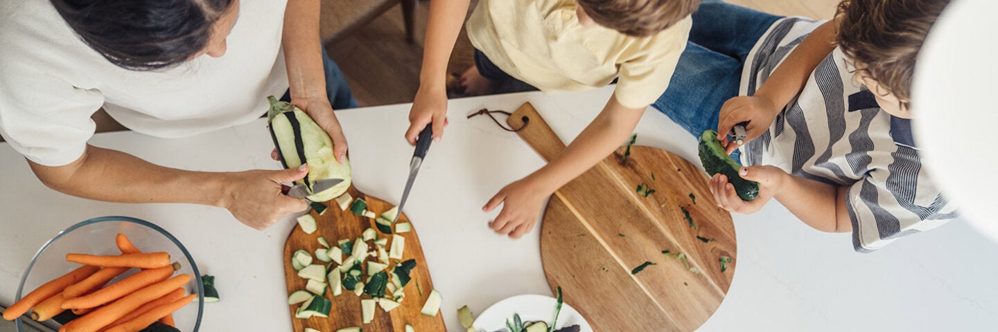 father making dinner with his young children