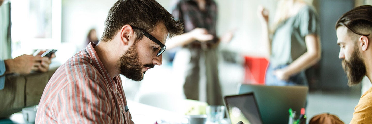 man focused on work with colleagues in the office