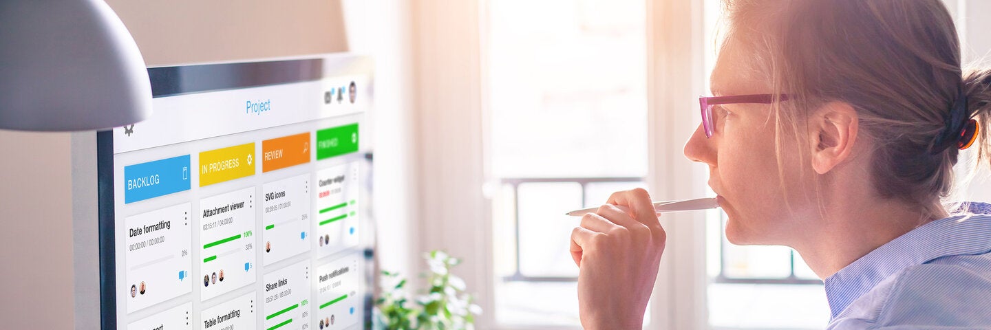 Woman at desk looking at computer screen