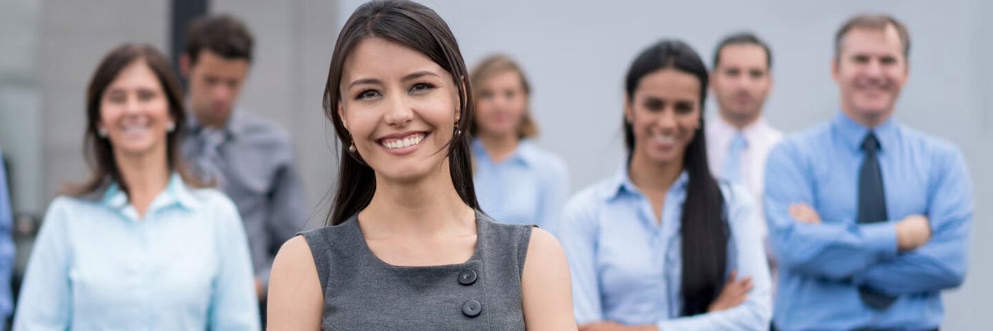 Business woman standing with coworkers