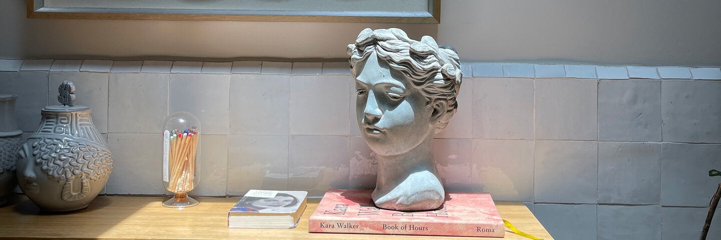 Head sculpture on table