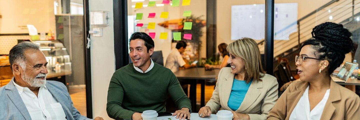 Spanish speaking business team talking in an office