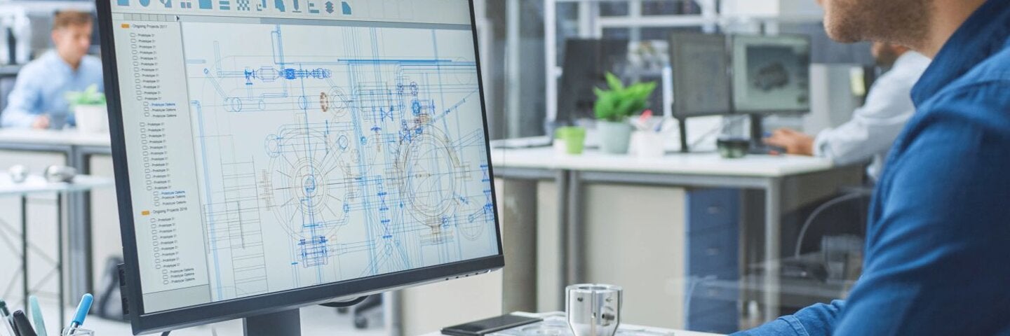 Over the Shoulder Shot of Engineer Working with CAD Software on Desktop Computer