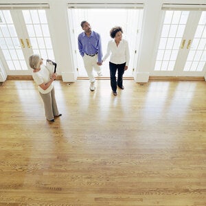Man and woman viewing a house with real estate agent