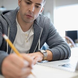 male writer holding pencil