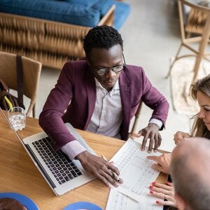 accountant working with two clients at a table