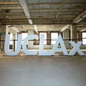 Large physical letters of UCLAx in a sparce building