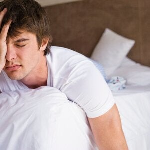 man in bed frustrated by a lack of sleep