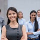 Business woman standing with coworkers